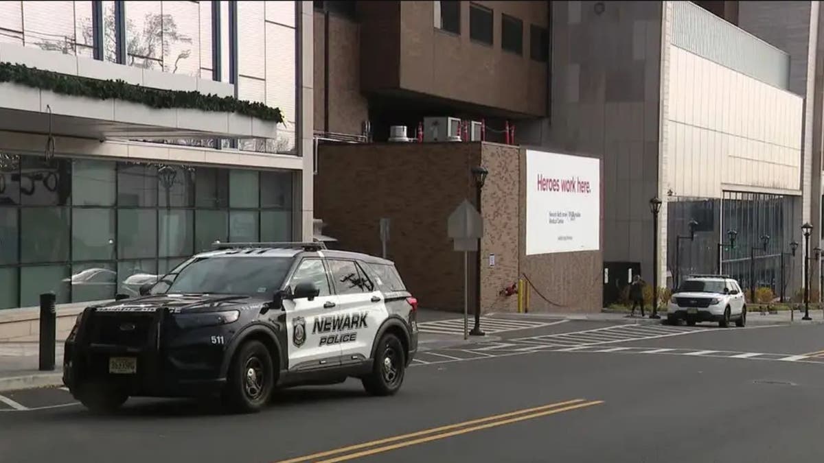 The front of Newark Beth Israel Hospital and a police vehicle parked outside.