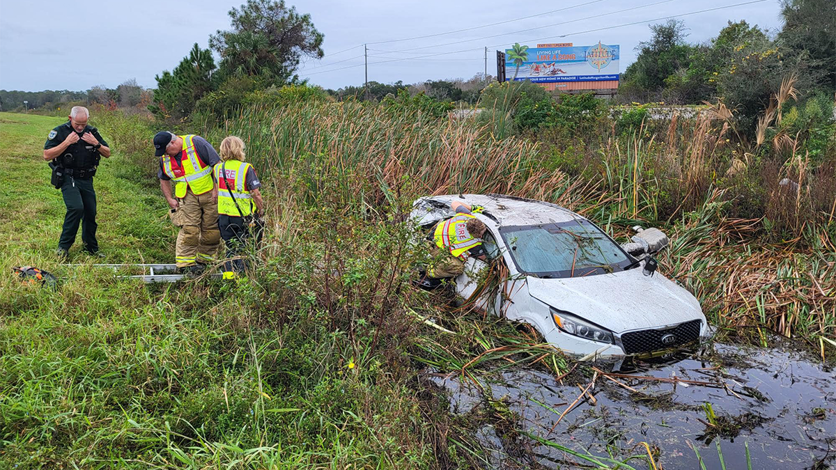 First responders on ladder to access gifts in vehicle