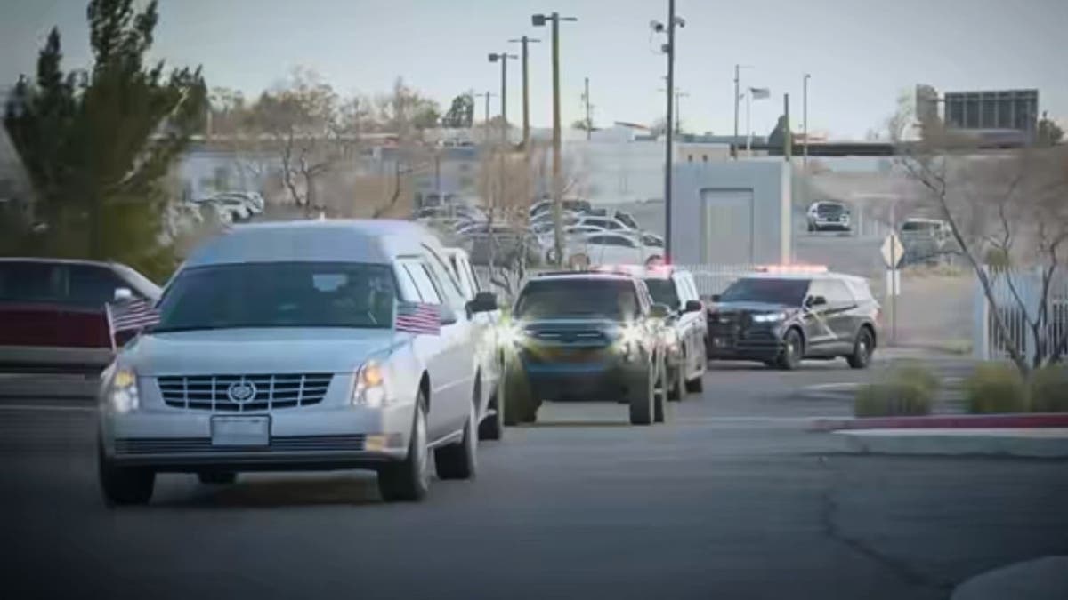 Police cars and a hearse carrying Officer Hare