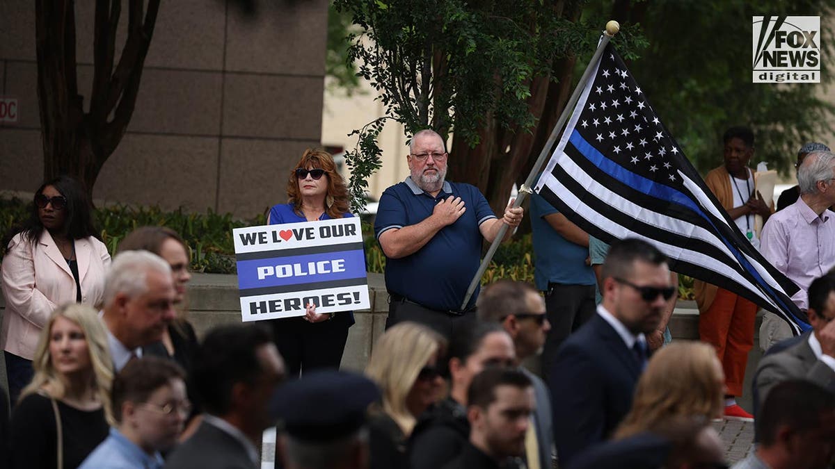 Supporters hold a blue line flag in the street