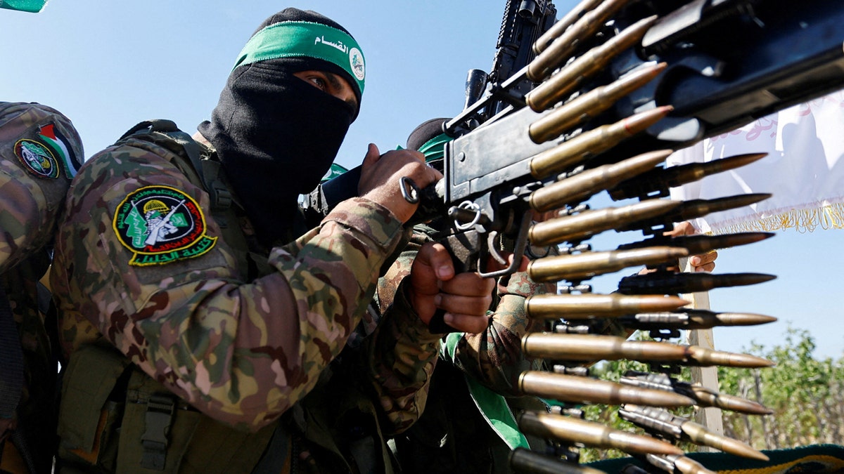 Hamas fighter in camo and balaclava with gun