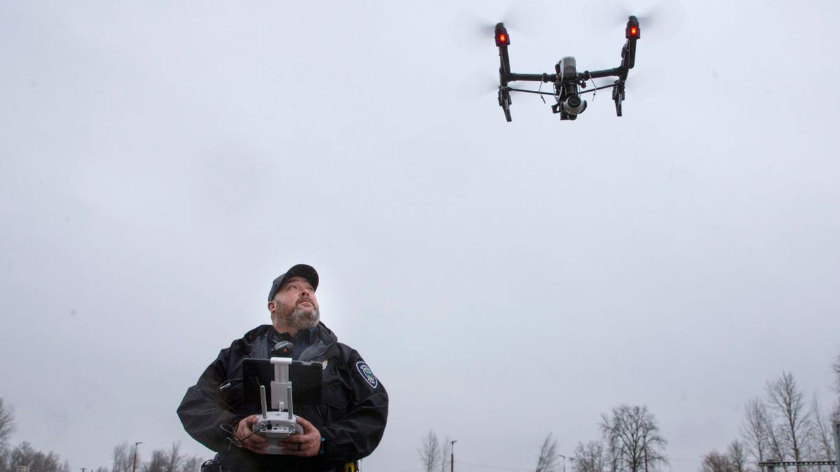 Police drone in air with officer controlling