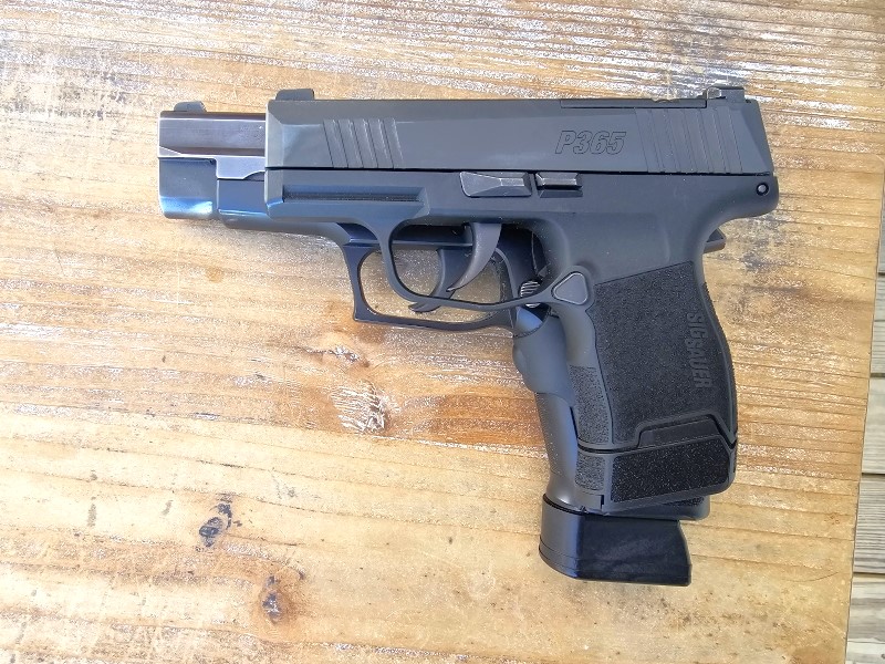 A P365 laid on top of a P226 for size comparison.