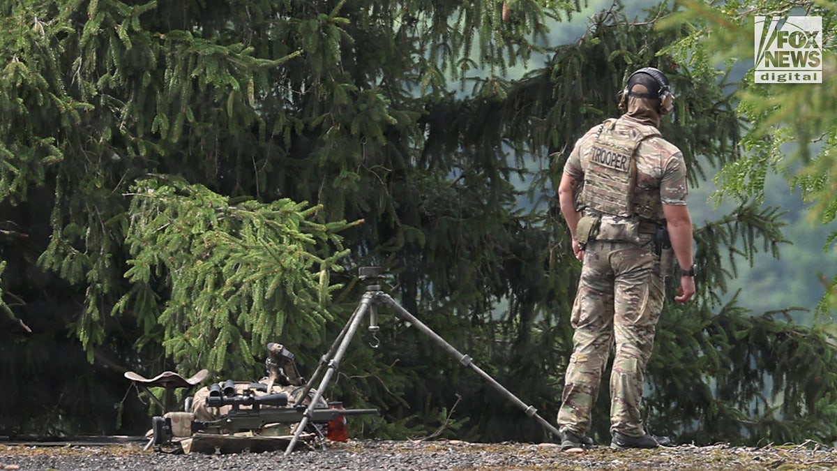 A state trooper counter sniper patrols the area around Laube Hall for the celebration of life for Corey Comperatore