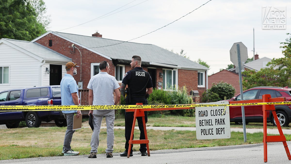 Two men chat with a local cop.