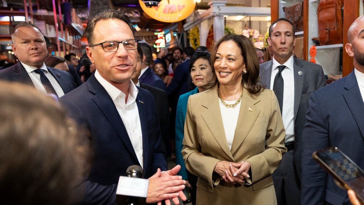 Vice President Kamala Harris and Pennsylvania Governor Josh Shapiro (L) speak to the press