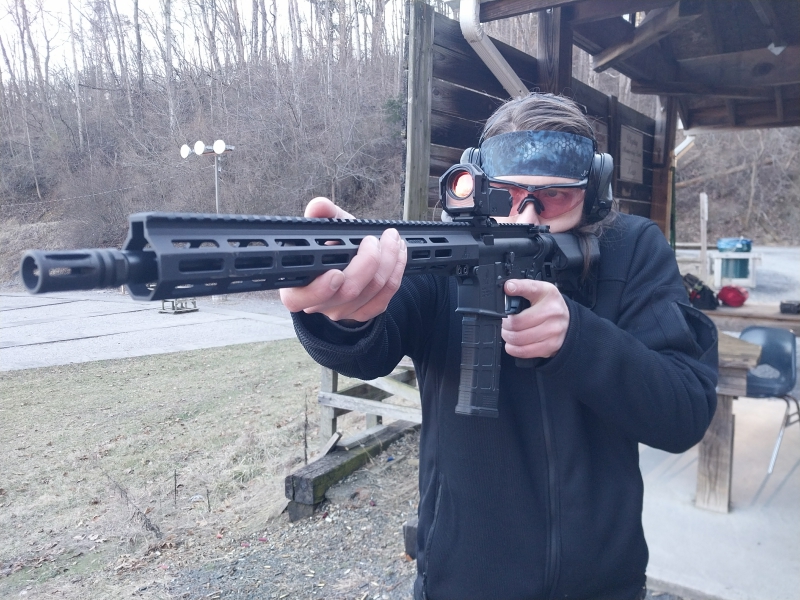 man shooting an AR-15 rifle