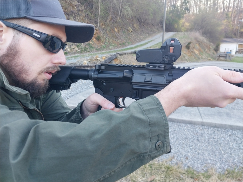 close-up of a man firing an IWI Zion-15 rifle