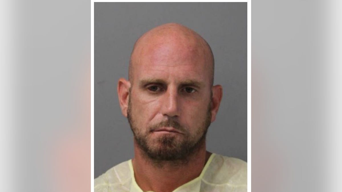 Daniel Tomasky has a bald head and short bread in his mugshot