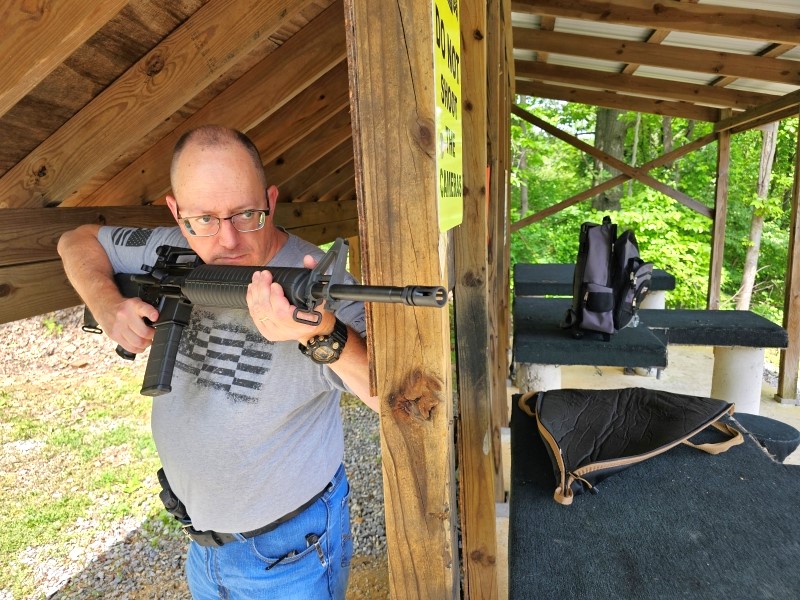 AR-15 rifle around a corner.