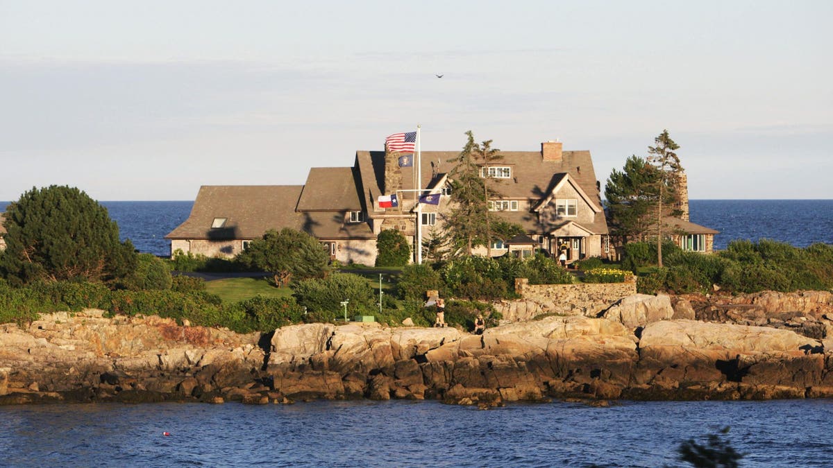 Waterfront Bush compound in Kennebunkport, ME with a US flag flying in the wind