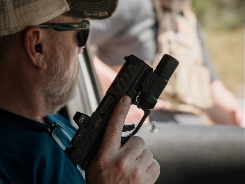 man in vehicle with gun