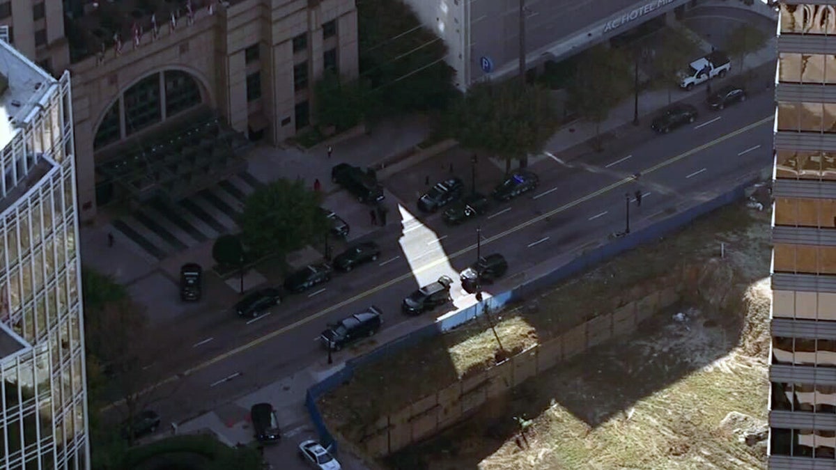 A large police presence is seen outside the hotel.