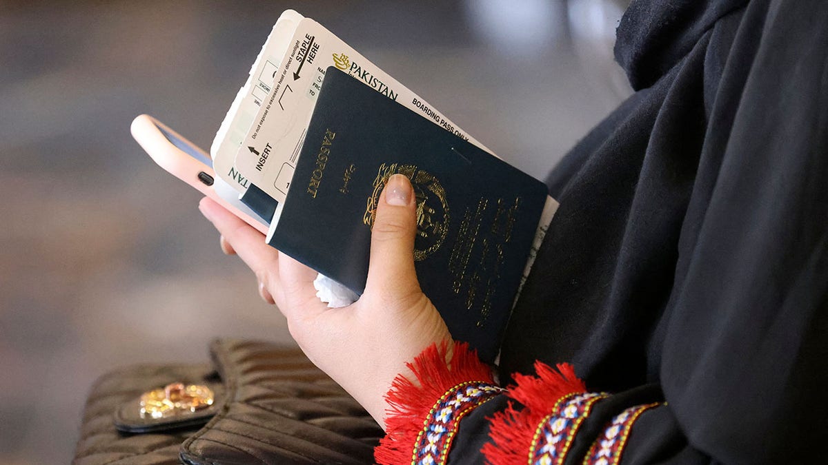 A woman holds her passport