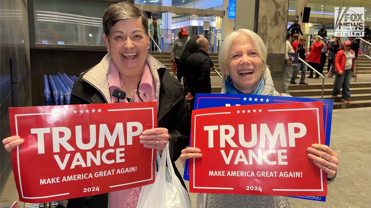 Two female supporters with Trump signs outside the Trump Madison Square Garden rally