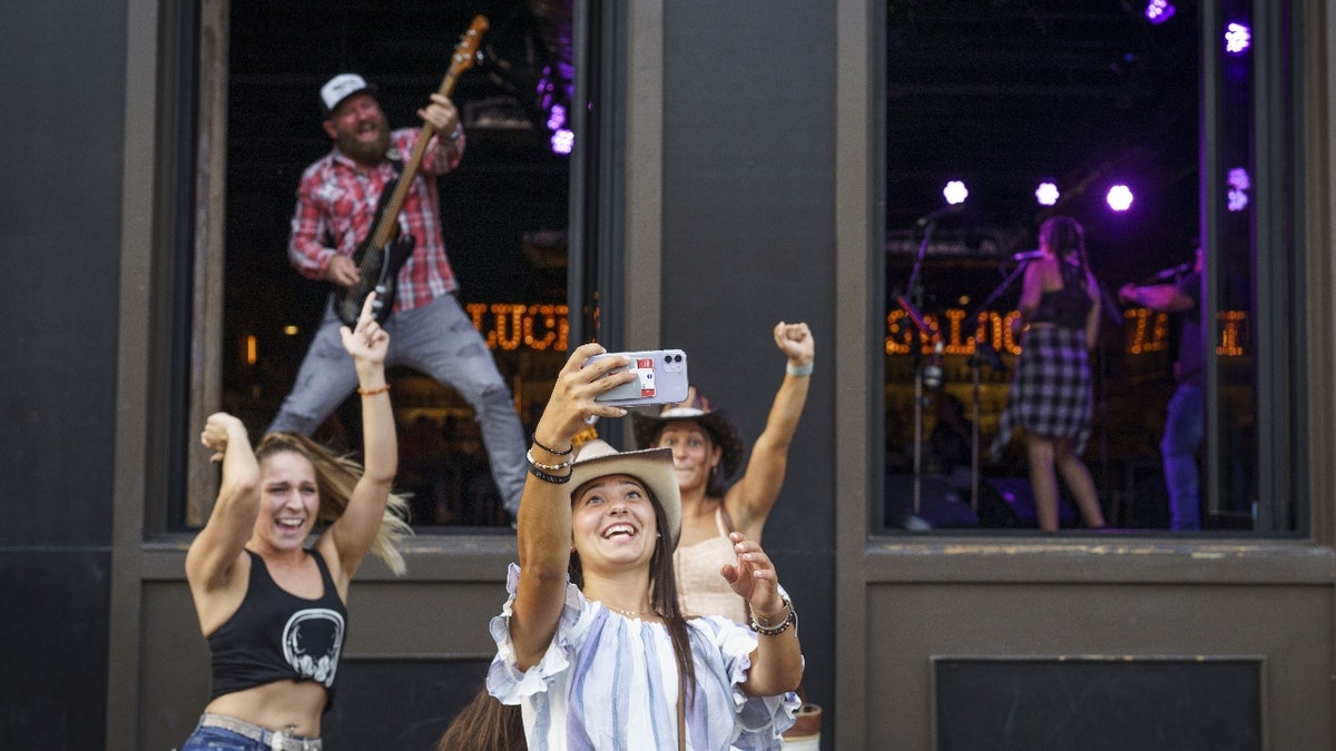 Women pose for a selfie in downtown Nashville