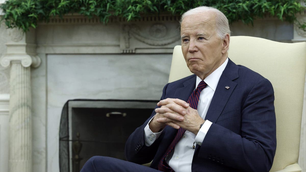 biden sitting with his hands together