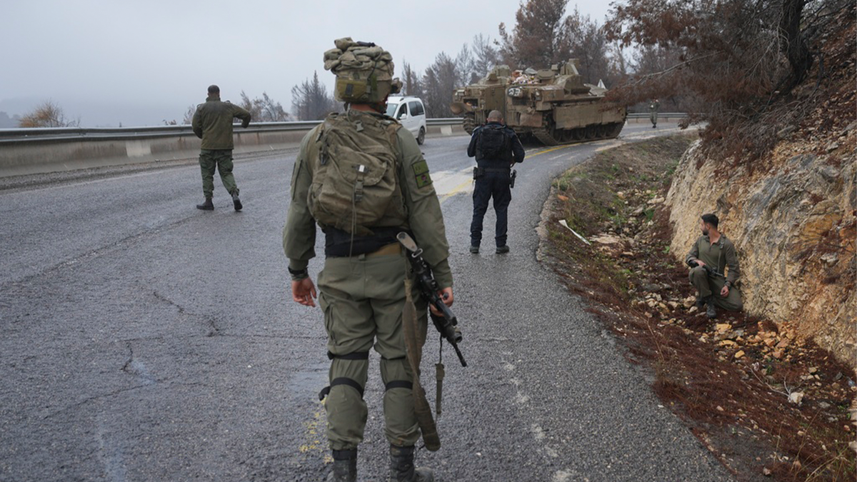 Israeli soldier in front of traffic