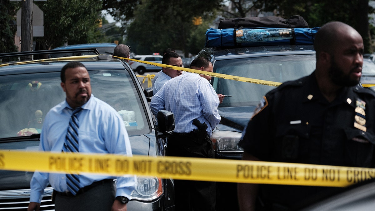 NYPD officers surrounded by police tape