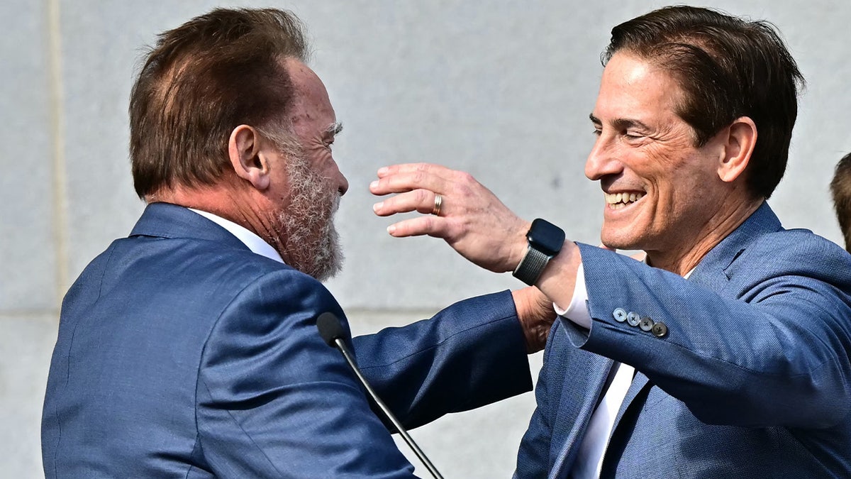 Nathan Hochman (R) greets former California Governor Arnold Schwarzenegger 