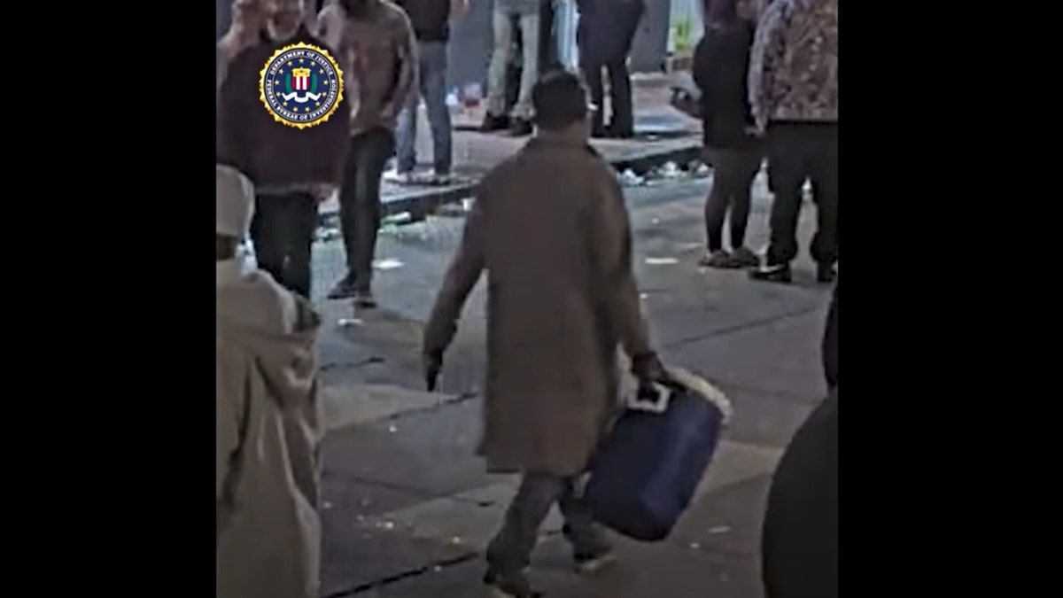 Jabbar seen carrying a cooler on wheels in surveillance video from the French Quarter on New Year's Eve.