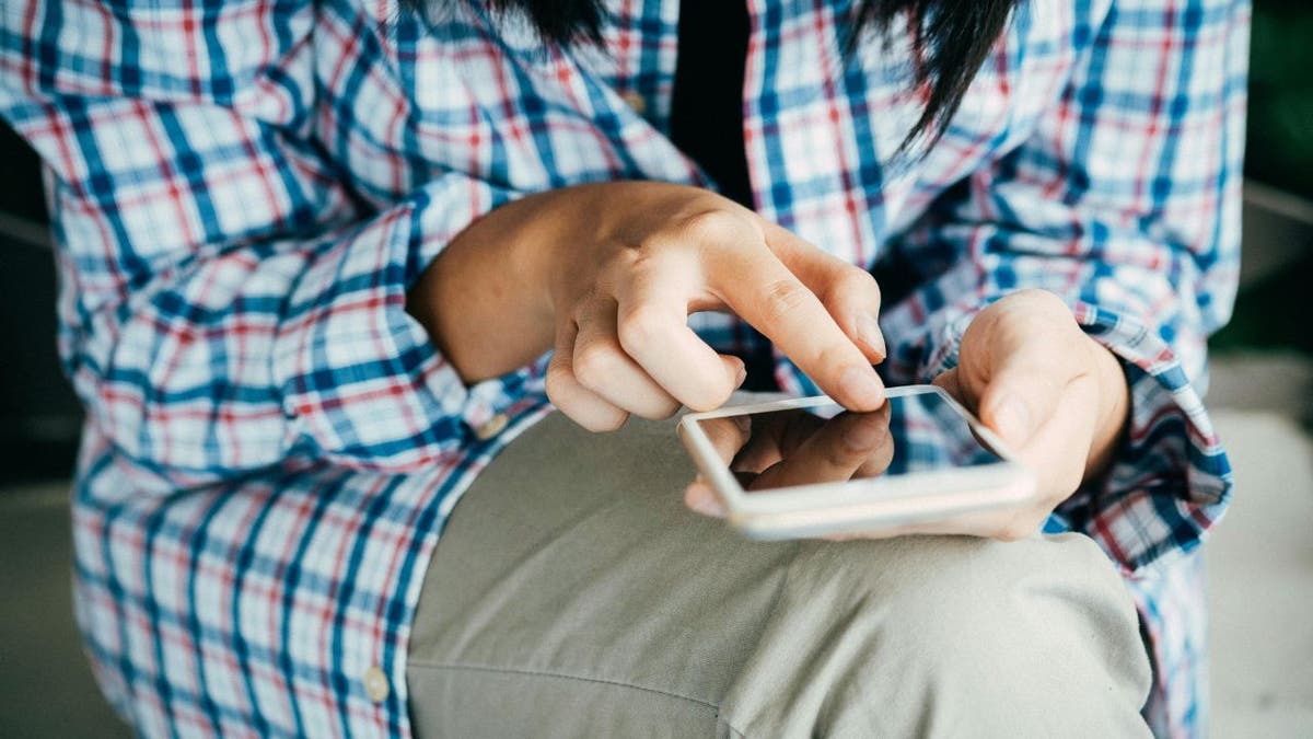 seated person texting