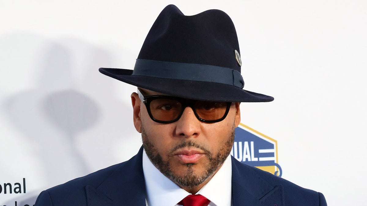 Al B. Sure! wears a hat and glasses at Hollywood event.