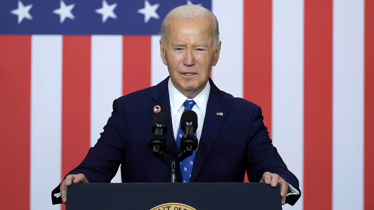 President Joe Biden closeup shot at lectern, US flag behind him