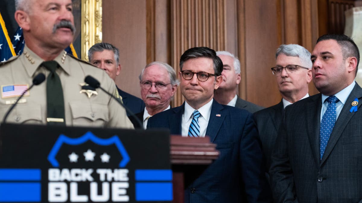 House Speaker Mike Johnson listens to Sheriff Chad Bianco speak during a news conference in the U.S. Capitol on May 15, 2024. (Tom Williams/CQ-Roll Call, Inc via Getty Images)