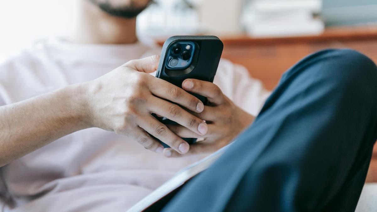 man scrolling phone