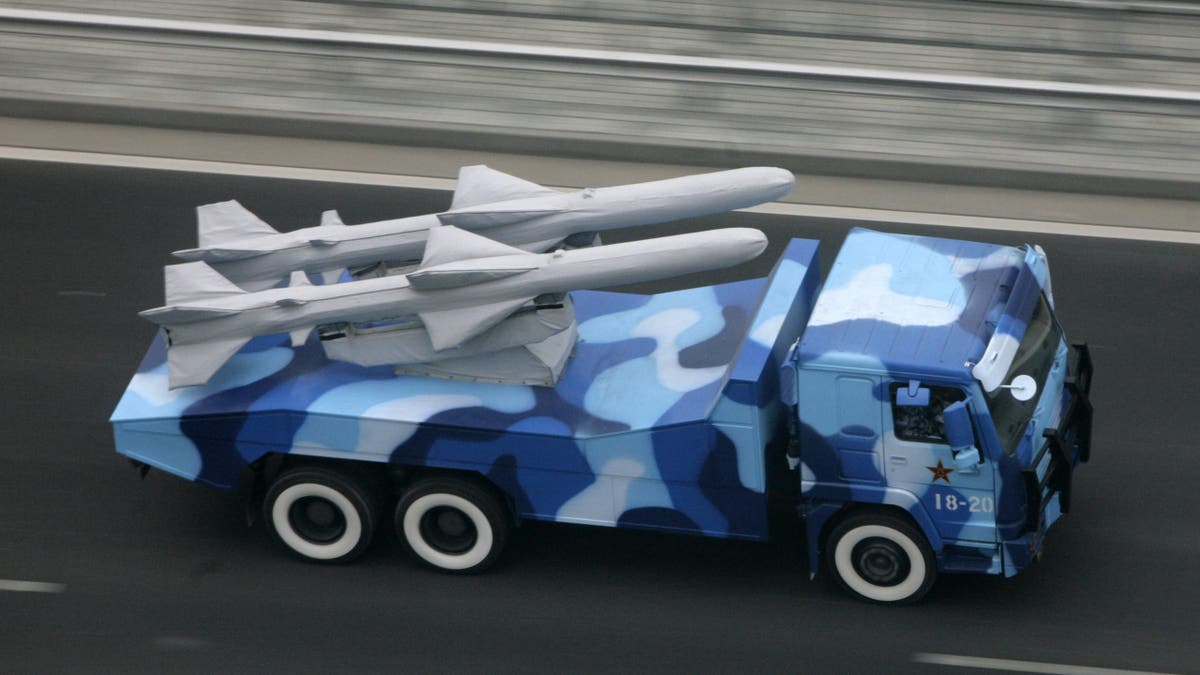 A military vehicle carrying anti-ship missiles drives towards Tiananmen Square, ahead of a rehearsal for the 60th anniversary of the founding of the People's Republic of China