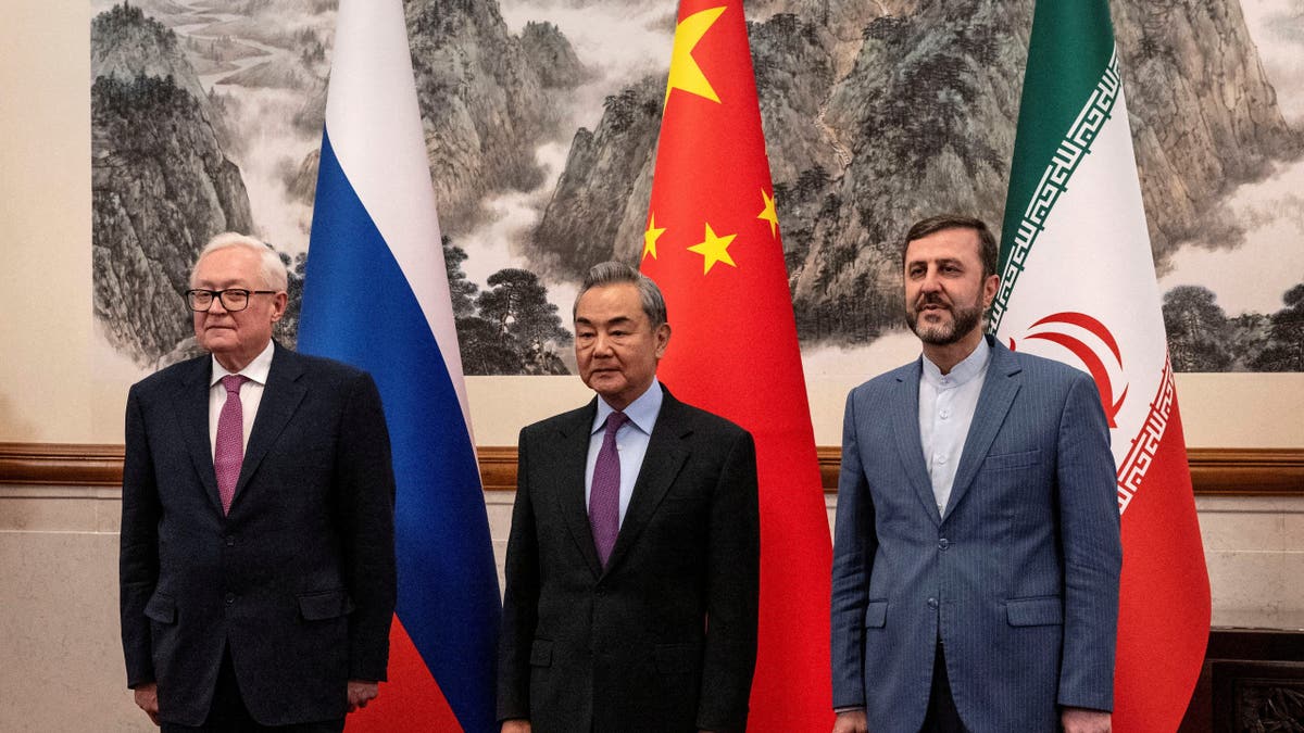 The foreign ministers of China, Russia and Iran pose for a photo