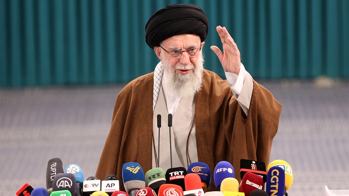 Ali Khamenei speaking to reporters.