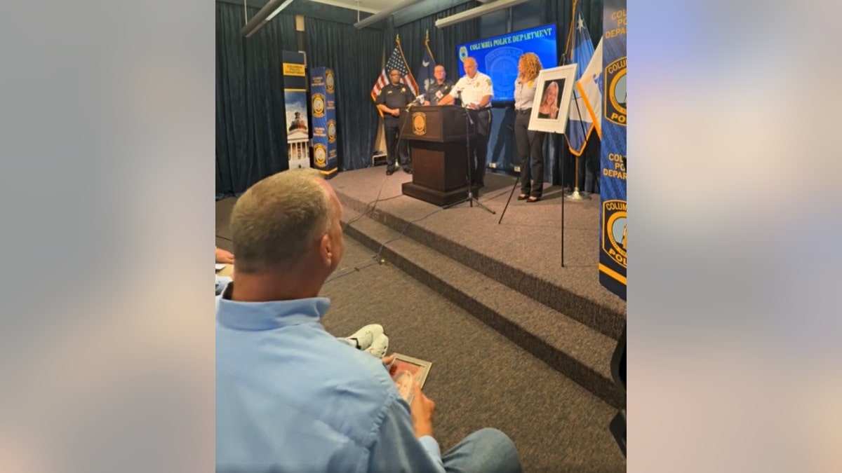 Stephen Federico holds a photo of his daughter during a May 5 press conference.