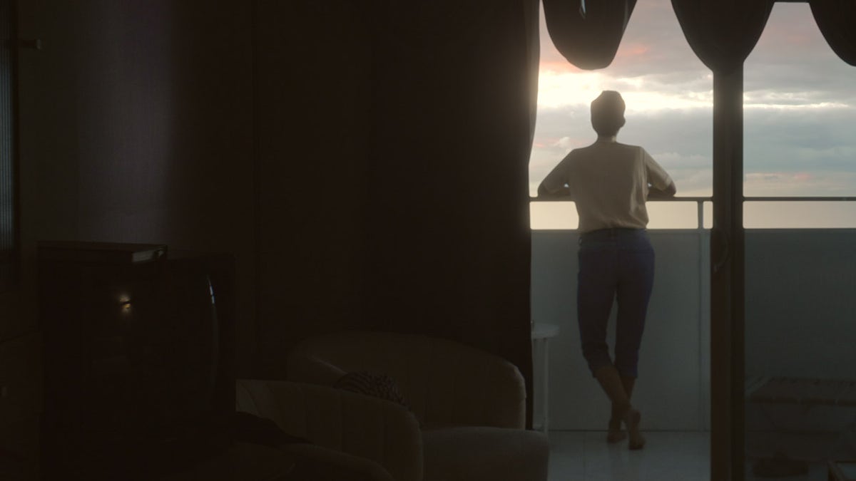 Amy Bradley looking at a sunset from a cruise ship.