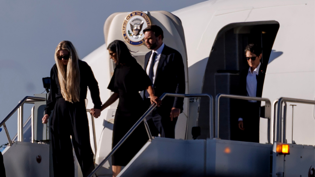 Second lady Usha Vance holds the hand of Charlie Kirk's wife