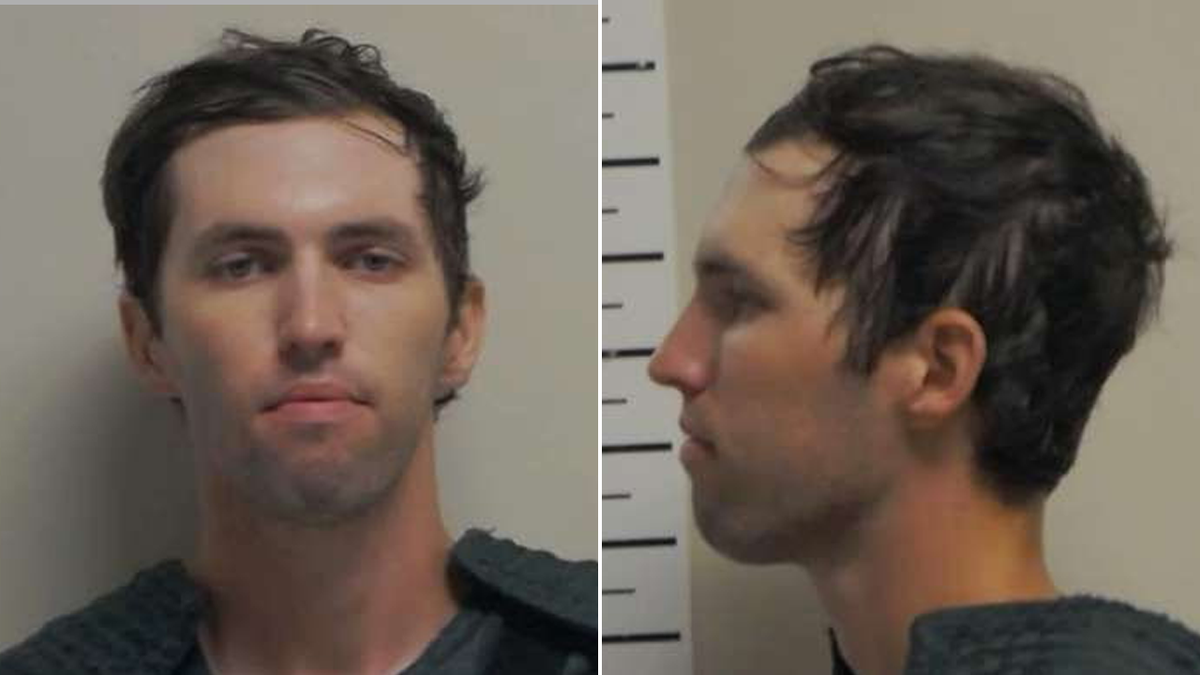 Tyler Robinson in a pair of mugshot photos, showing his portrait and profile. he has brown hair, hazel eyes, and a clean shave
