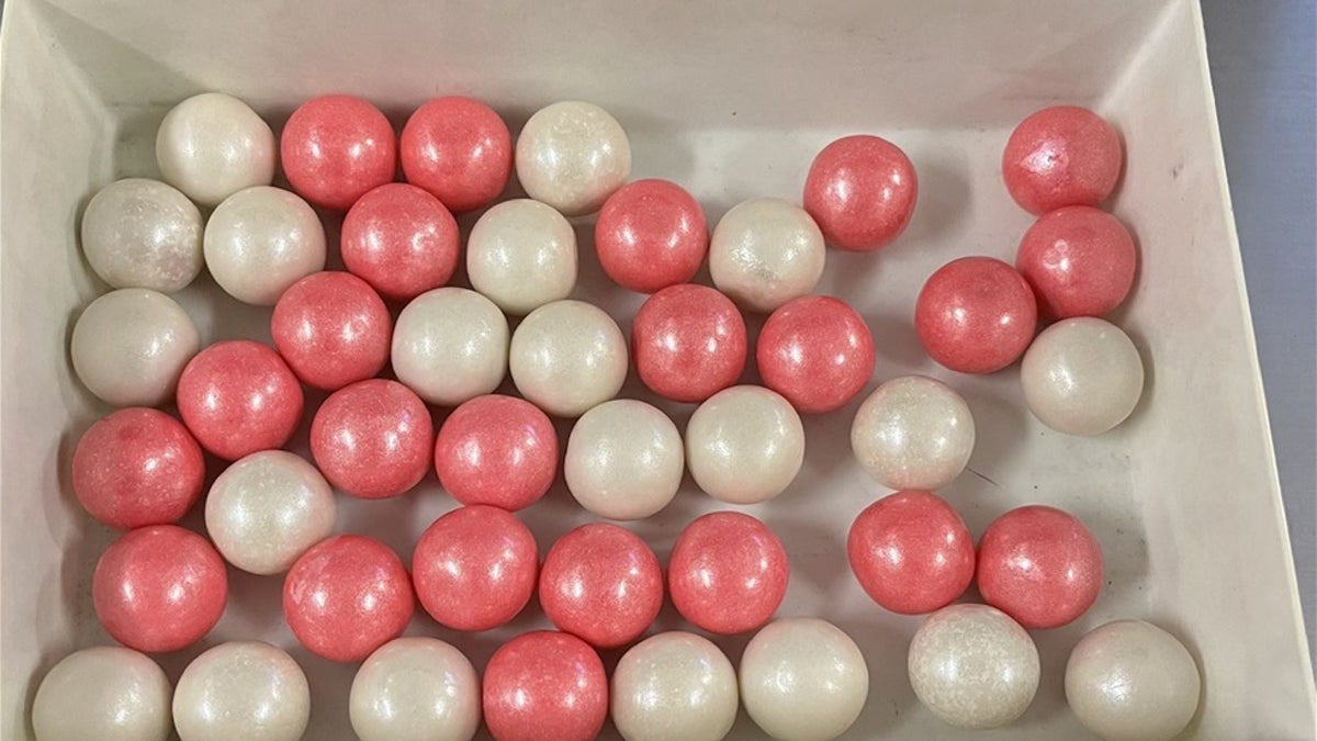 A bowl of pink and white gumball-style candies made with Fentanyl