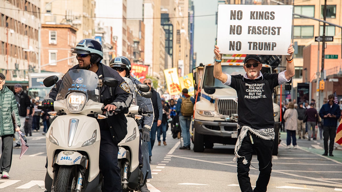 "No Kings" protestors hold signs and march in New York City