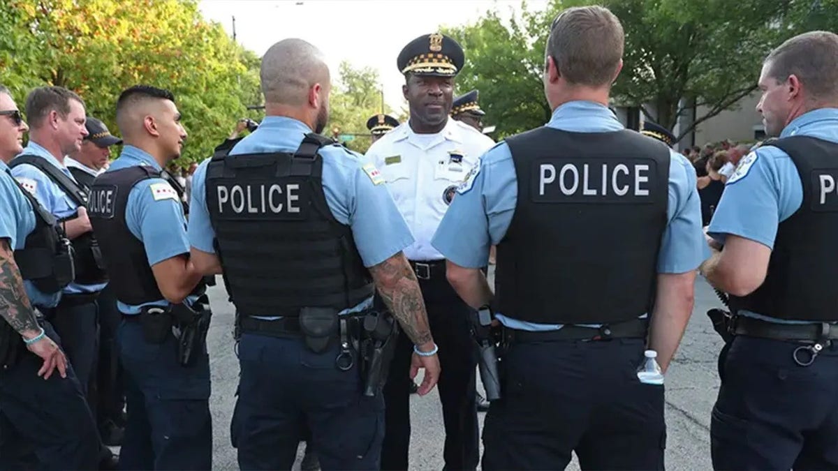 Chicago Police Superintendent Larry Snelling standing outside talking to officers