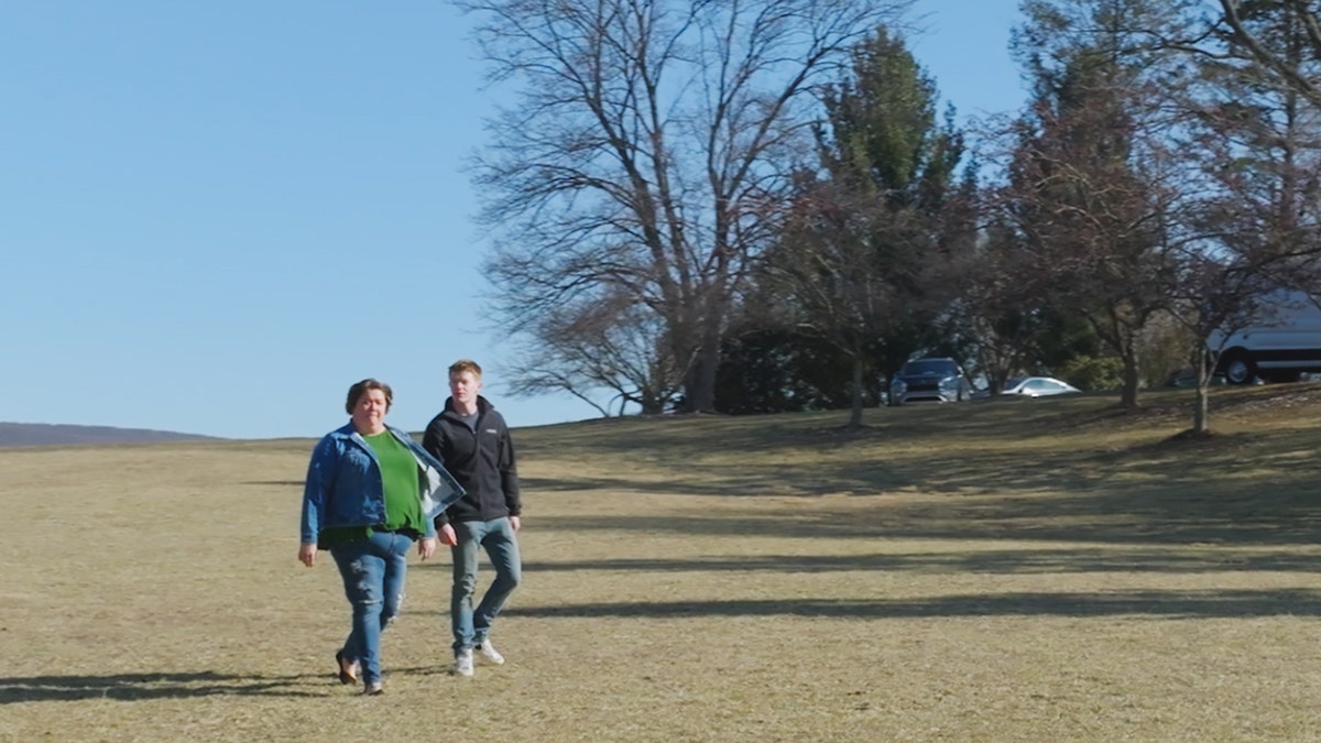 Stacey Rutherford walking with her son Tyler outdoors.