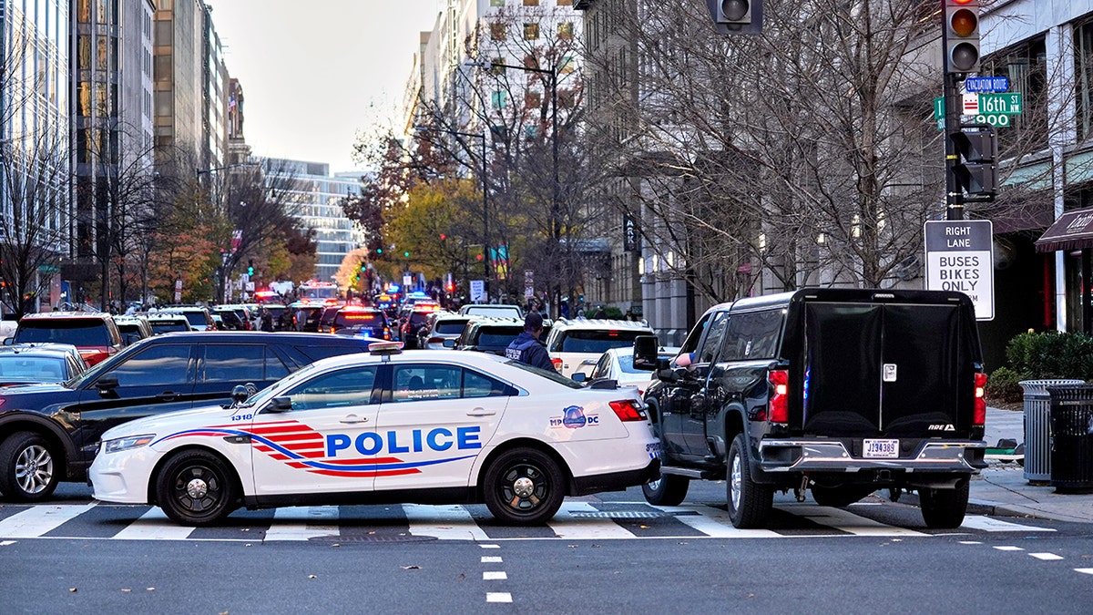 police vehicles block street