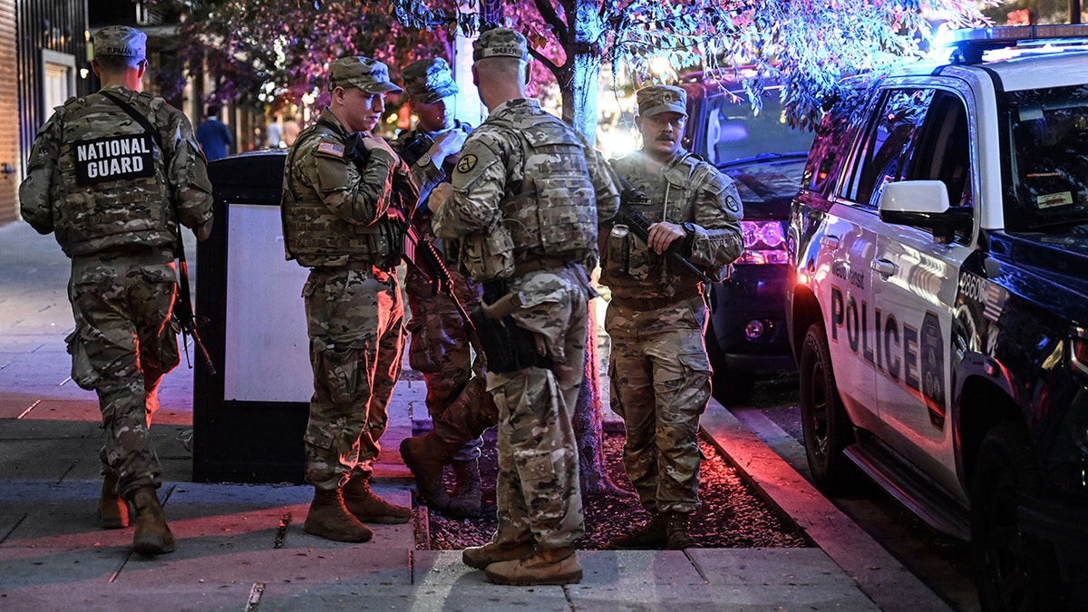 National Guard members stand on sidewalk in Washington, DC