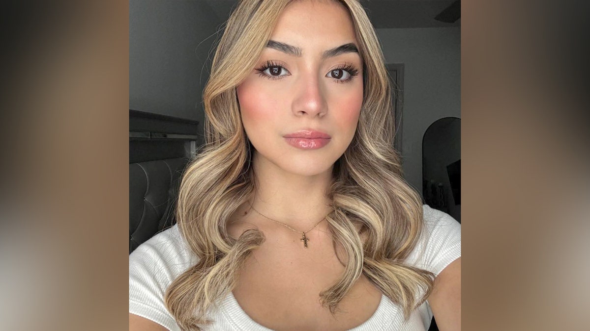 Brianna Aguilera takes a selfie in a white shirt