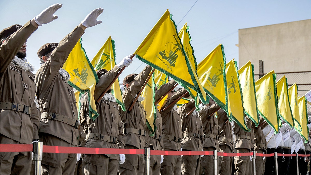 Hezbollah members saluting