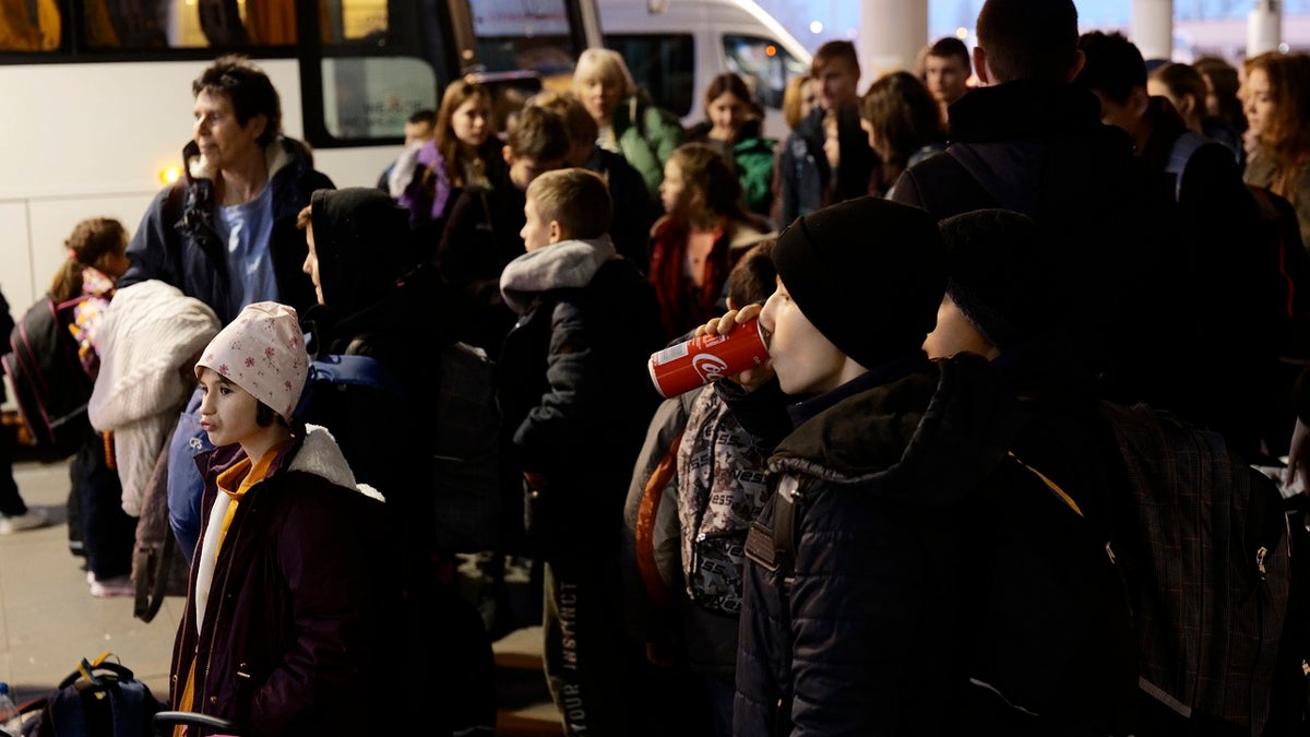Orphans getting ready to board a train.