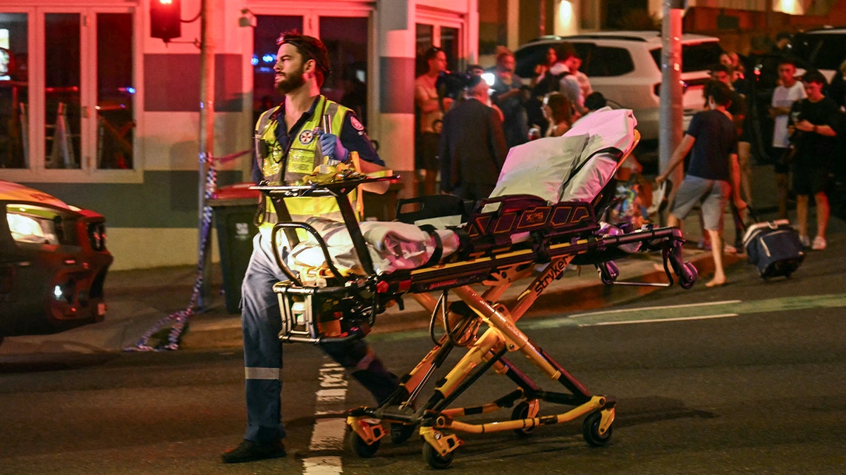 Australian paramedic pushing stretcher after mass shooting