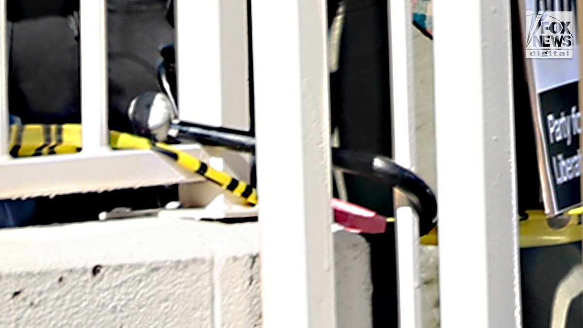 A lock blocks a parking lot gate from opening