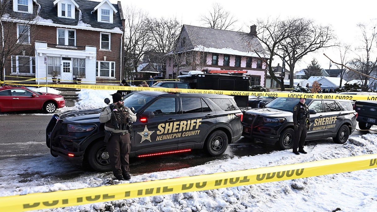 Police gather outside the scene of a suspected shooting by an ICE agent
