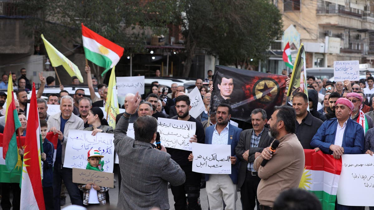 people demonstrate in Qamishli, Syria,